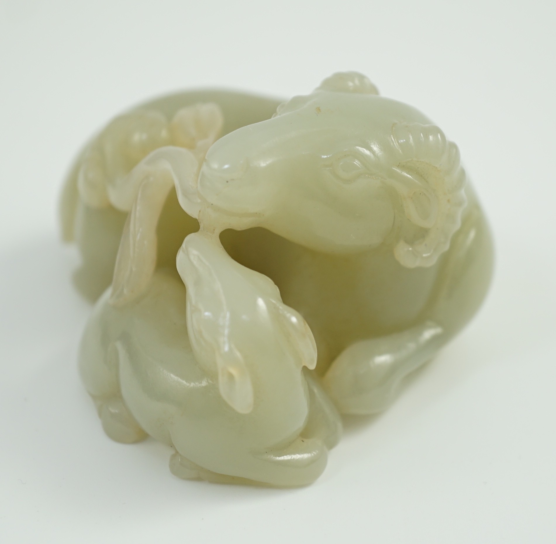 A Chinese pale celadon jade ram group, 7cm long